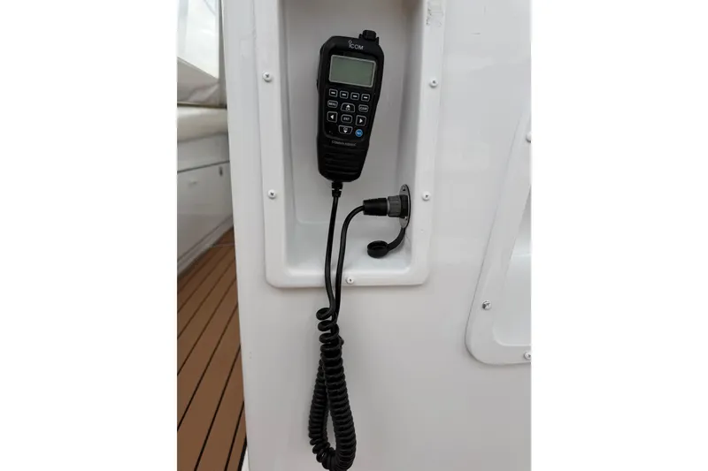 Slide: The Image of Marine radio handset on 1985 Bertram 54 Convertible yacht, mounted on white panel. - 16