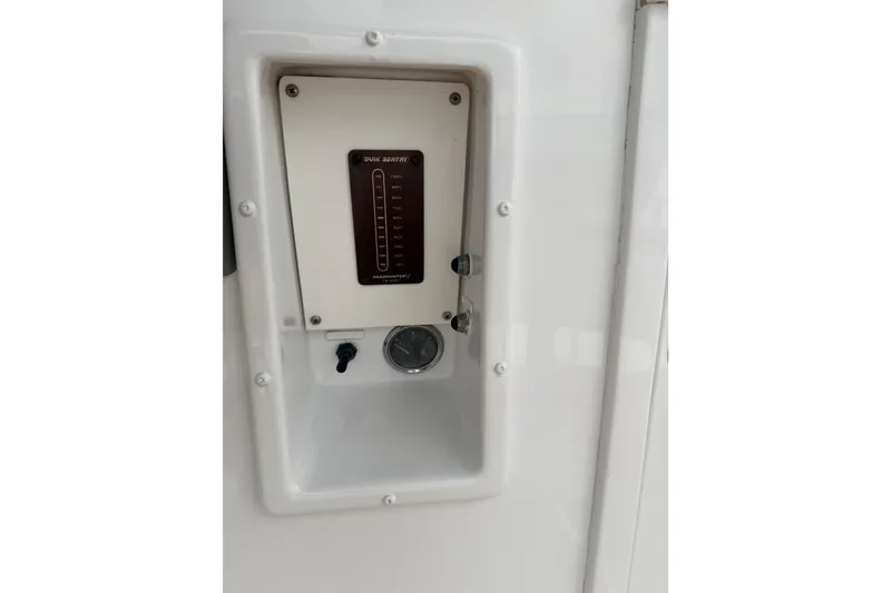 Slide: The Image of Control panel on a 1985 Bertram 54 Convertible boat, featuring a tank level indicator. - 17