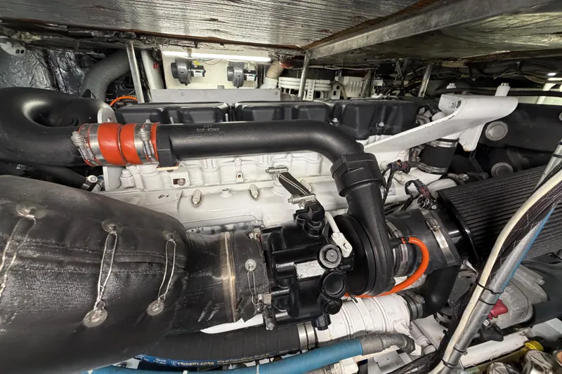 Slide: The Image of Engine room of a 1985 Bertram 54 Convertible yacht, showcasing detailed mechanical components. - 21