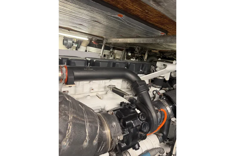 Slide: The Image of Engine compartment of a 1985 Bertram 54 Convertible boat, showcasing mechanical components. - 22