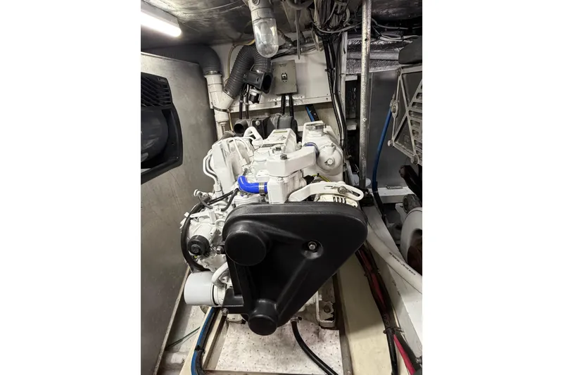 Slide: The Image of Engine room of a 1985 Bertram 54 Convertible yacht, showcasing mechanical components. - 24