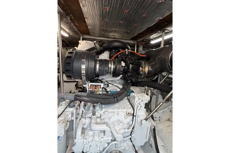 Slide: The Image of Engine room of a 1985 Bertram 54 Convertible yacht, showcasing detailed machinery. - 28