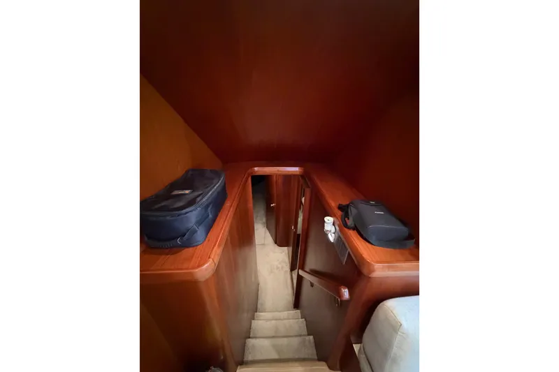 Slide: The Image of Interior stairs of 1985 Bertram 54 Convertible yacht with wooden finish. - 29