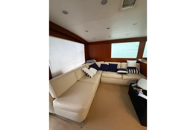 Slide: The Image of Interior of 1985 Bertram 54 Convertible yacht with beige seating and nautical-themed cushions. - 30