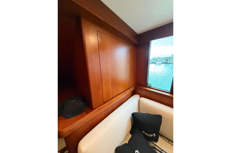 Slide: The Image of Interior of 1985 Bertram 54 Convertible yacht with wooden paneling and waterfront view. - 35