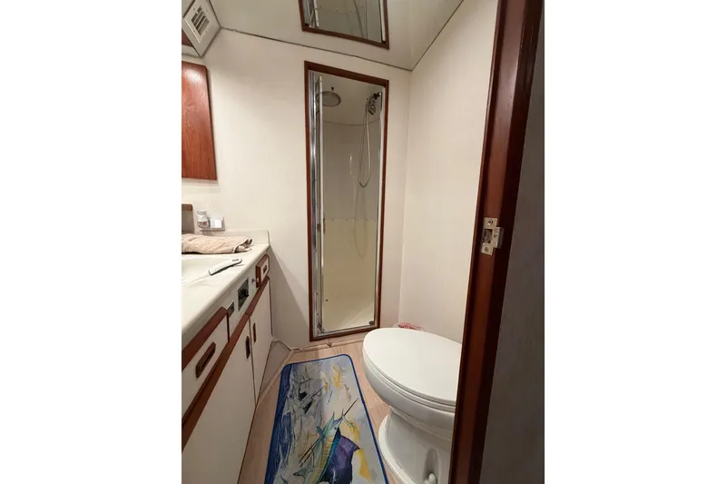 Slide: The Image of Bathroom interior of 1985 Bertram 54 Convertible yacht, featuring shower and toilet. - 37