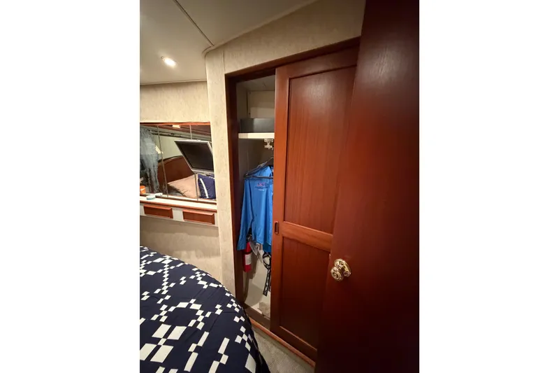 Slide: The Image of Interior of 1985 Bertram 54 Convertible yacht with wooden closet and bed. - 38