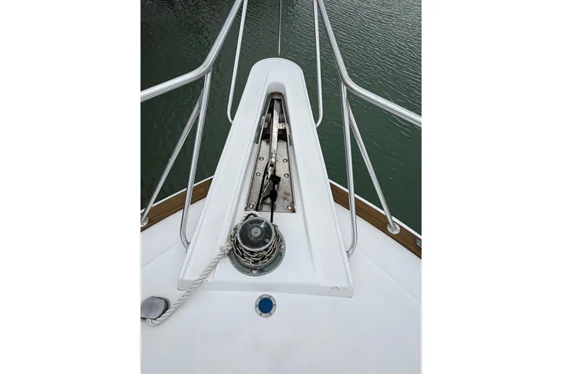 Slide: The Image of Bow of 1985 Bertram 54 Convertible yacht with anchor chain and railing. - 6
