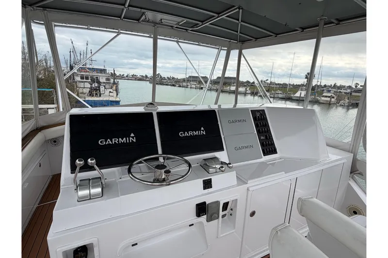 Slide: The Image of 1985 Bertram 54 Convertible yacht helm with Garmin navigation, docked in marina. - 9