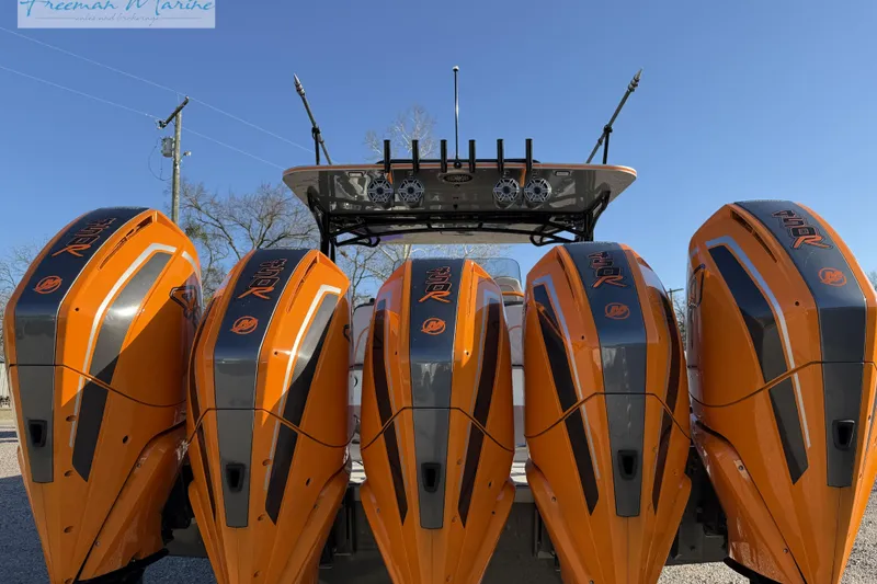 Slide: The Image of 2020 Midnight Express 43 Open with four vibrant orange outboard engines. - 10