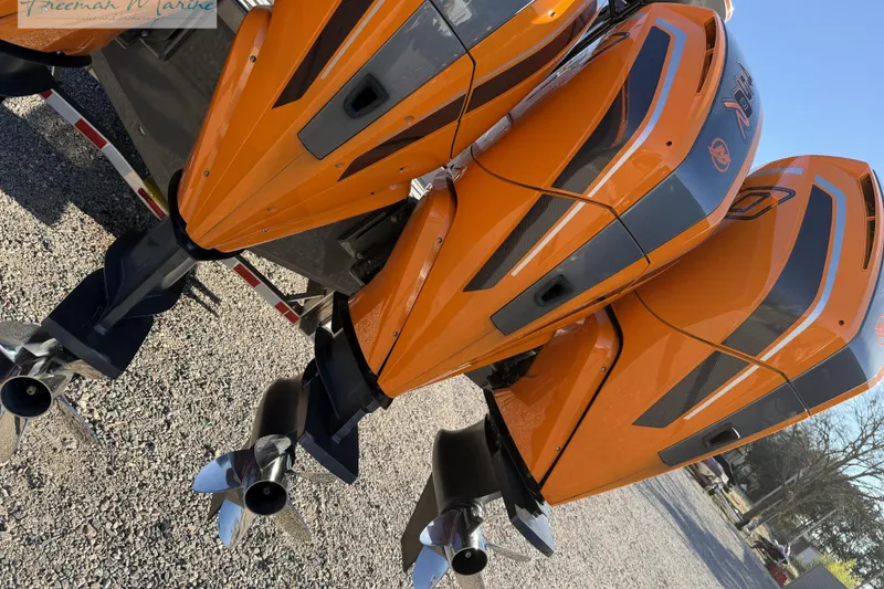 Slide: The Image of Orange outboard motors on a 2020 Midnight Express 43 Open boat. - 12