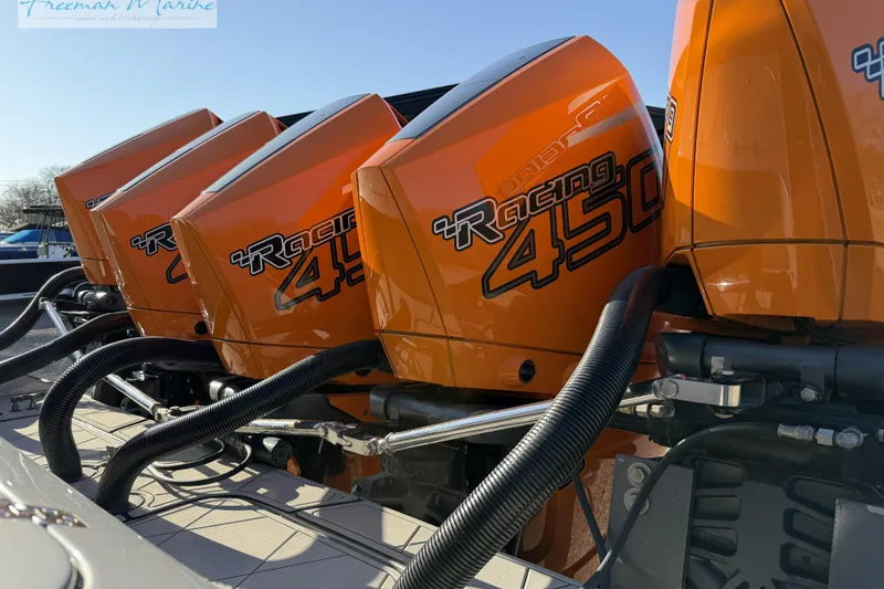 Slide: The Image of Four orange Racing 450 outboard engines on a 2020 Midnight Express 43 Open boat. - 13