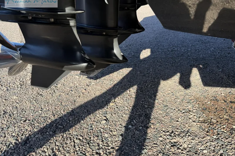 Slide: The Image of Outboard motors of a 2020 Midnight Express 43 Open boat on gravel surface. - 19