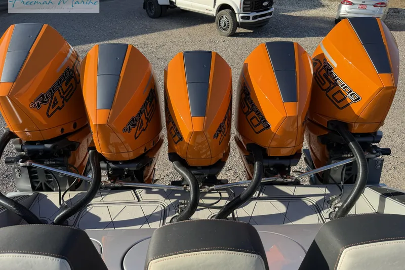 Slide: The Image of Five orange Racing 450 outboard engines on a 2020 Midnight Express 43 Open boat. - 27