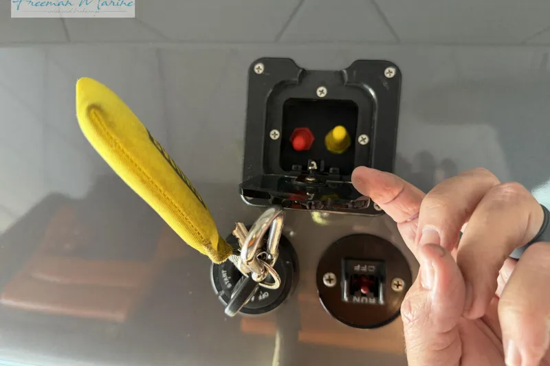 Slide: The Image of Close-up of a 2020 Midnight Express 43 Open boat control panel with key and switches. - 28