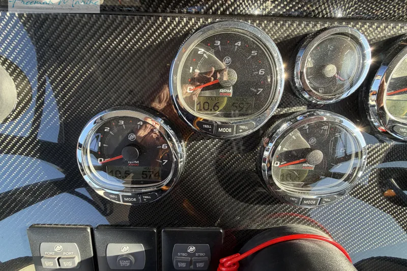 Slide: The Image of Dashboard of 2020 Midnight Express 43 Open boat with carbon fiber finish and gauges. - 33