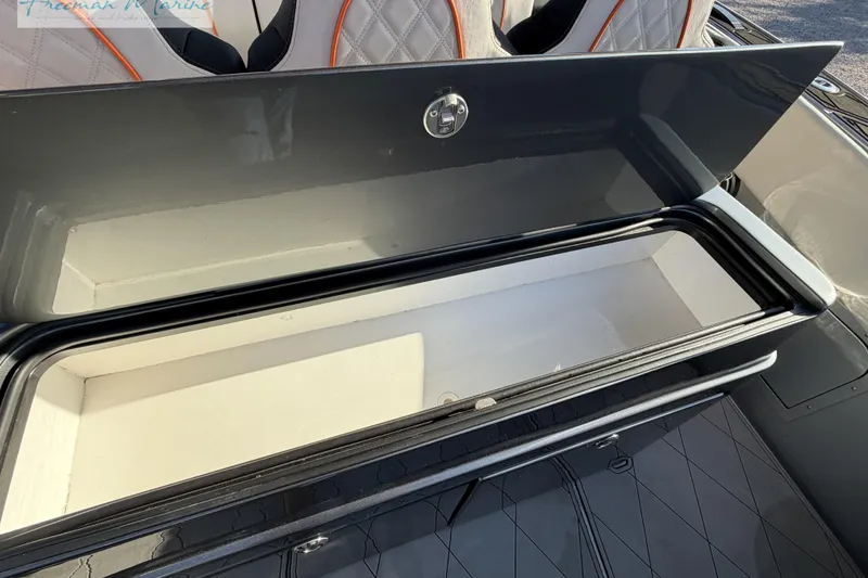 Slide: The Image of Open storage compartment on 2020 Midnight Express 43 Open boat, featuring quilted seating. - 35