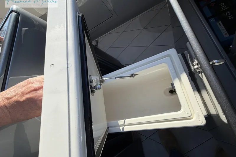 Slide: The Image of Open storage compartment on a 2020 Midnight Express 43 Open boat. - 38