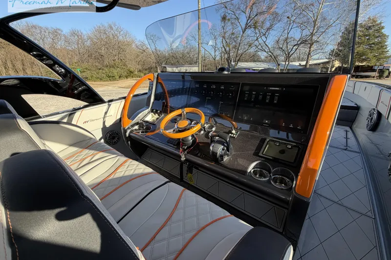 Slide: The Image of 2020 Midnight Express 43 Open boat cockpit with modern controls and orange accents. - 49