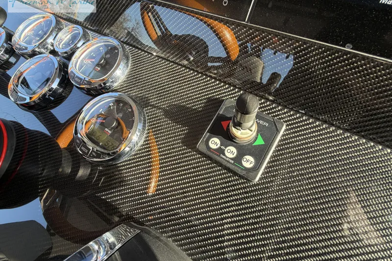 Slide: The Image of Dashboard of 2020 Midnight Express 43 Open with carbon fiber finish and control gauges. - 51