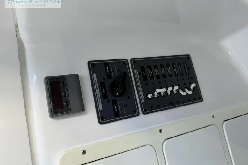 Slide: The Image of Control panel of a 2020 Midnight Express 43 Open boat, featuring switches and dials. - 54
