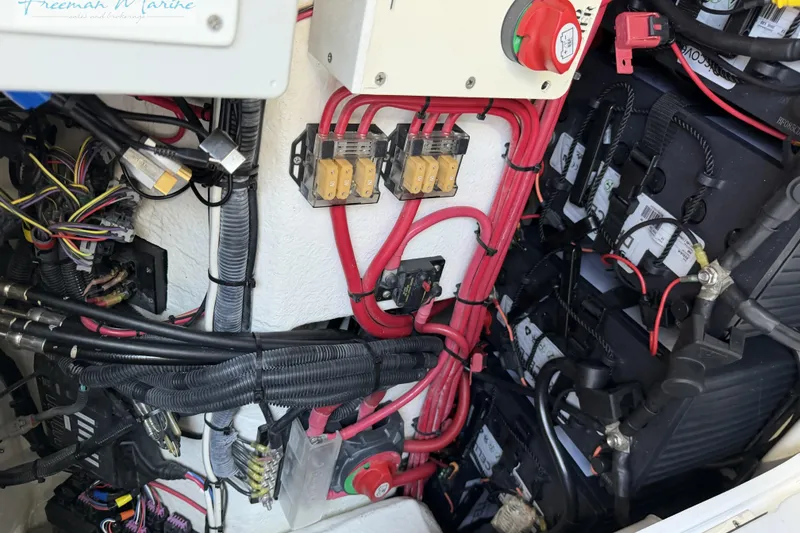 Slide: The Image of Electrical wiring and components inside a 2020 Midnight Express 43 Open boat. - 56