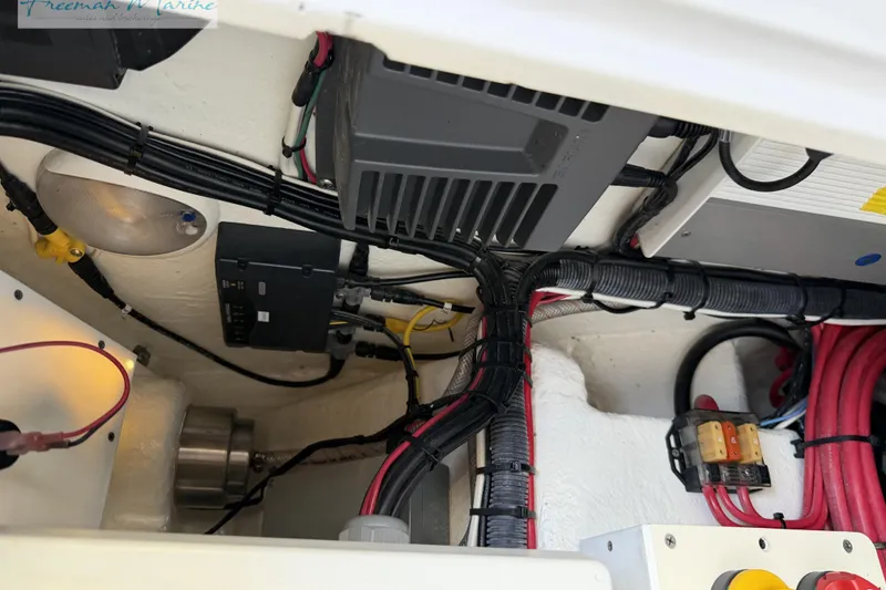 Slide: The Image of Electrical wiring and components inside a 2020 Midnight Express 43 Open boat. - 58