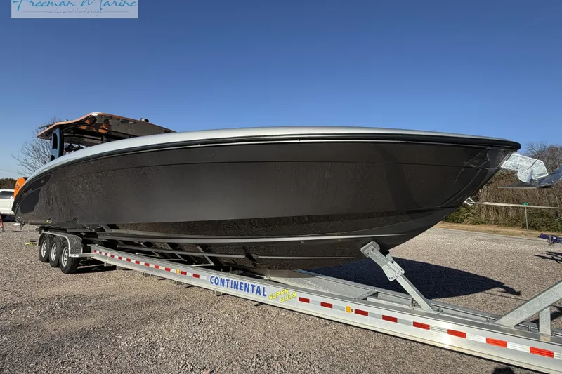 Slide: The Image of 2020 Midnight Express 43 Open boat on trailer under clear blue sky. - 6