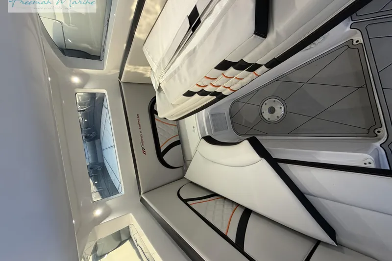 Slide: The Image of 2020 Midnight Express 43 Open cabin interior with sleek white seating and modern design. - 61