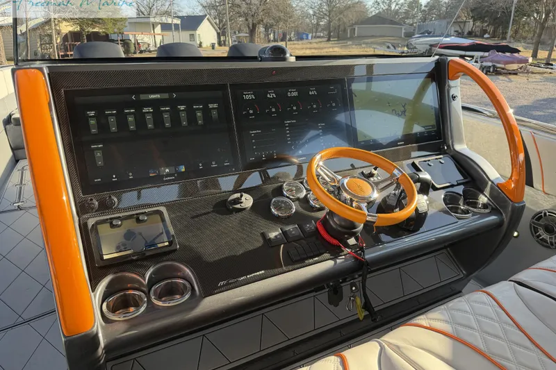 Slide: The Image of 2020 Midnight Express 43 Open boat dashboard with orange accents and advanced navigation controls. - 67