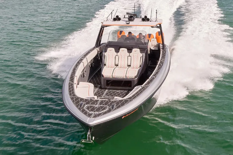 Slide: The Image of 2020 Midnight Express 43 Open boat cruising on clear water, showcasing sleek design and luxury seating. - 74