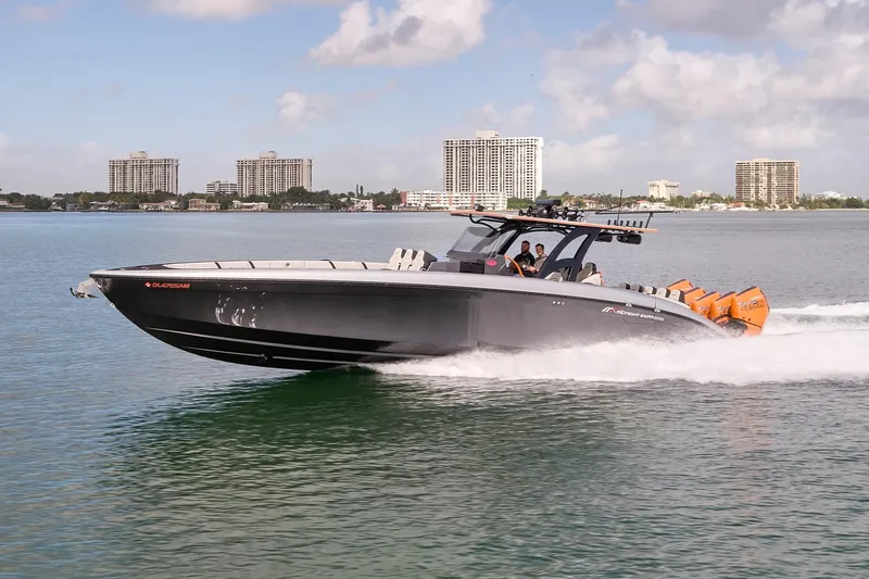 Slide: The Image of 2020 Midnight Express 43 Open boat cruising on water with city skyline in background. - 77