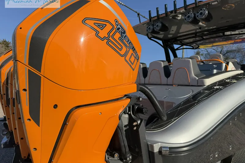Slide: The Image of 2020 Midnight Express 43 Open boat with vibrant orange 450R engines and sleek seating. - 9