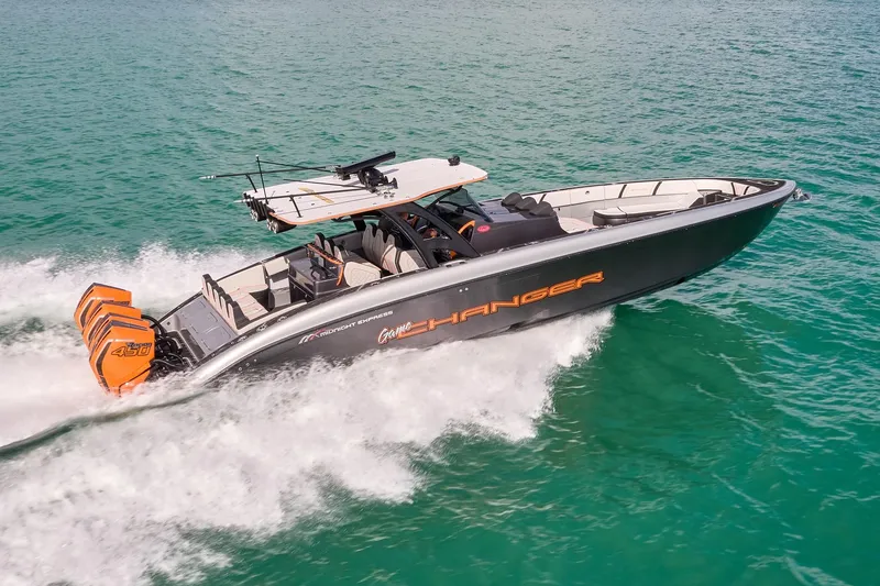 Slide: The Image of 2020 Midnight Express 43 Open boat cruising on turquoise water, featuring powerful engines. - 90