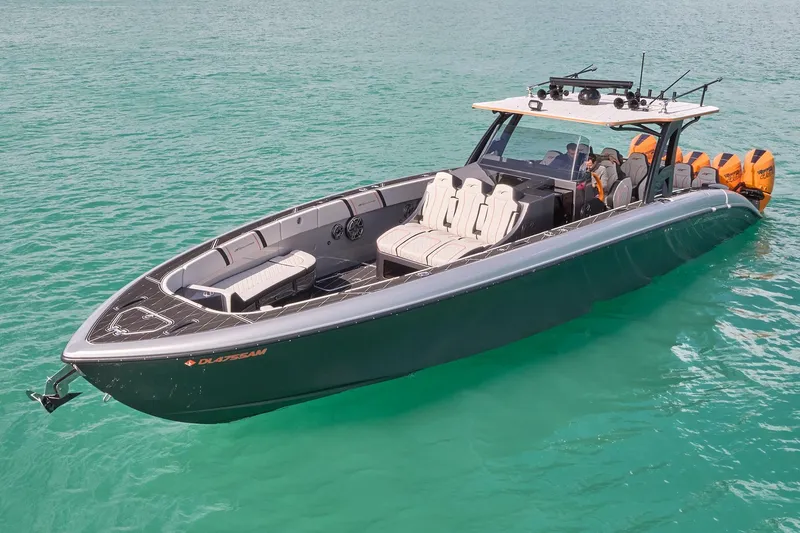 Slide: The Image of 2020 Midnight Express 43 Open boat on turquoise water, featuring sleek design and powerful engines. - 93