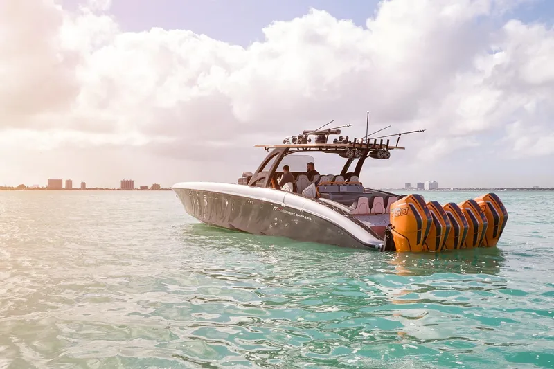 Slide: The Image of 2020 Midnight Express 43 Open boat with multiple engines on clear water under cloudy sky. - 95