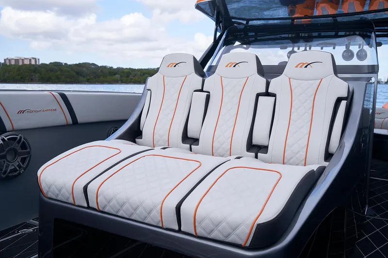 Slide: The Image of Luxurious seating on 2020 Midnight Express 43 Open boat with quilted design and orange accents. - 98
