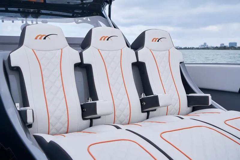 Slide: The Image of Luxury seating on 2020 Midnight Express 43 Open boat, featuring white and orange design. - 99