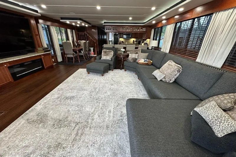 Slide: The Image of Luxurious 2022 Trifecta houseboat interior with spacious living area, plush seating, and modern kitchen. - 16
