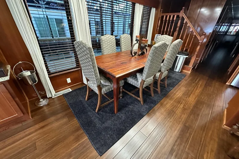 Slide: The Image of Luxurious dining area in 2022 Trifecta houseboat with elegant wooden table and chairs. - 18