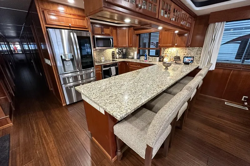 Slide: The Image of Luxurious 2022 Trifecta houseboat kitchen with granite countertops and modern appliances. - 21