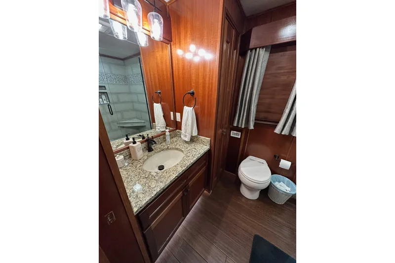 Slide: The Image of Luxurious 2022 Trifecta houseboat bathroom with granite countertop and modern fixtures. - 23