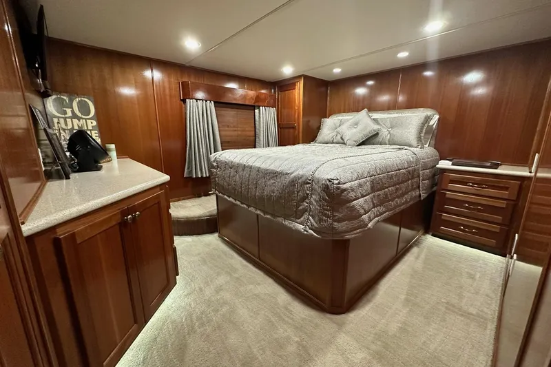 Slide: The Image of Luxurious 2022 Trifecta houseboat bedroom with elegant wood paneling and cozy bedding. - 32