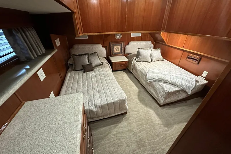Slide: The Image of Luxurious 2022 Trifecta houseboat bedroom with twin beds and elegant wood paneling. - 34