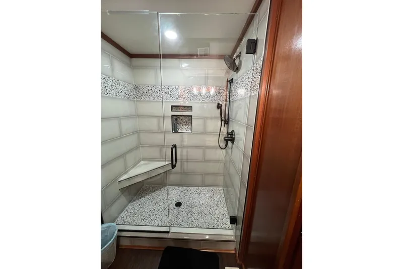 Slide: The Image of Modern shower in 2022 Trifecta houseboat with glass door and tiled interior. - 37
