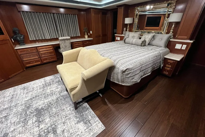 Slide: The Image of Luxurious 2022 Trifecta houseboat bedroom with elegant wood furnishings and plush bedding. - 38