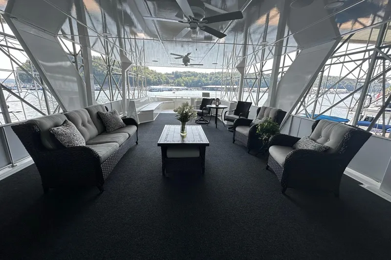 Slide: The Image of Luxurious 2022 Trifecta houseboat interior with elegant seating and scenic lake views. - 45