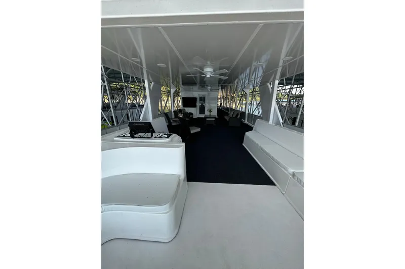 Slide: The Image of Spacious interior of 2022 Trifecta houseboat with modern seating and ceiling fan. - 46