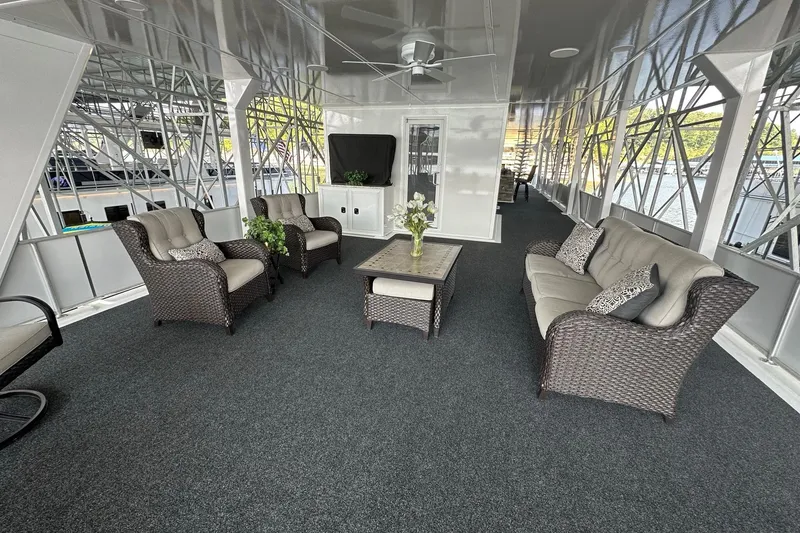 Slide: The Image of Luxurious 2022 Trifecta houseboat interior with elegant wicker furniture and scenic views. - 47
