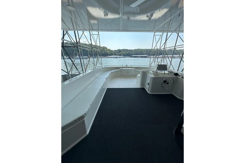 Slide: The Image of 2022 Trifecta houseboat interior with spacious seating and scenic water view. - 49